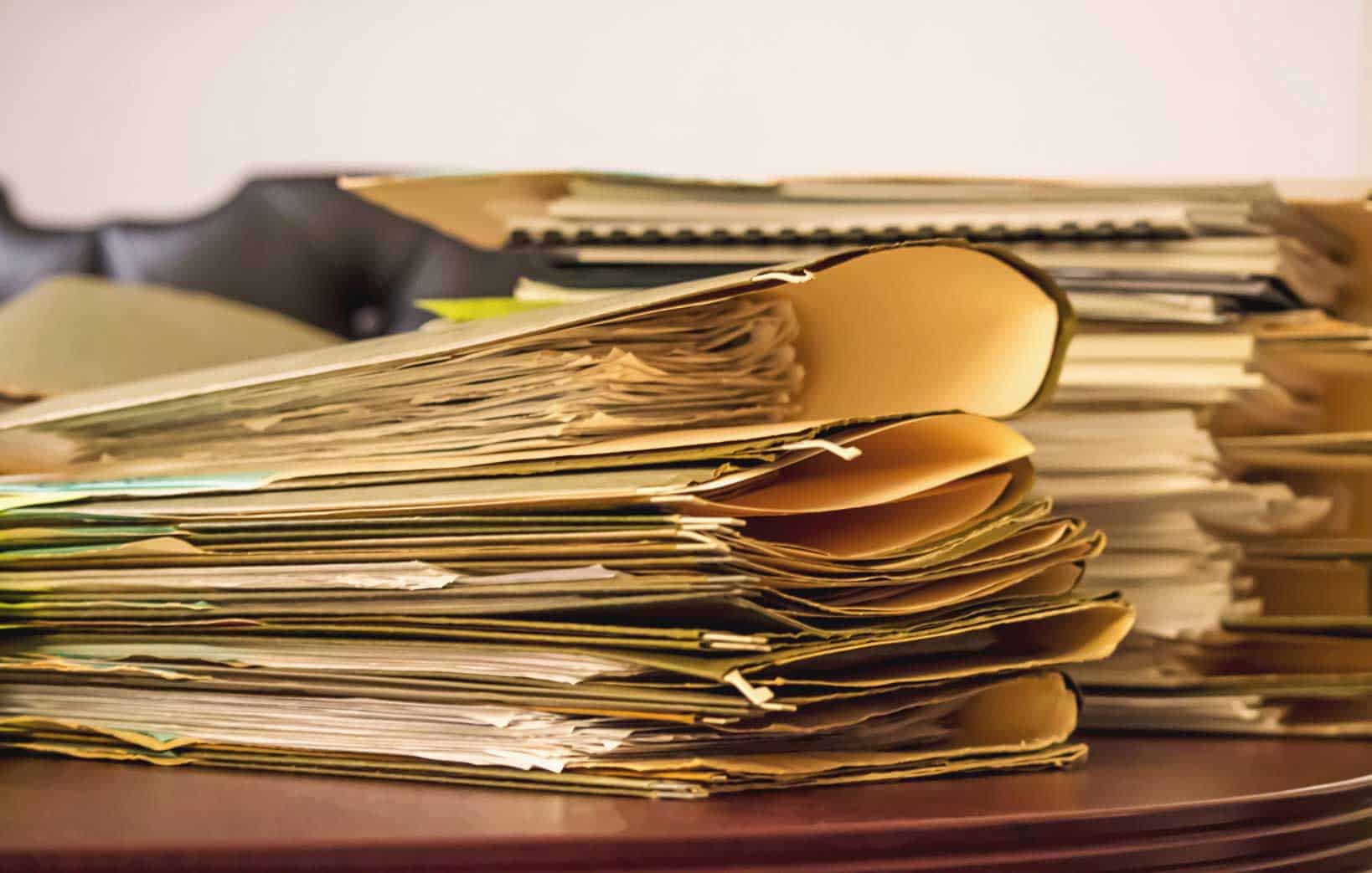 pile of folders for a company's filed chargeable income tax in Singapore