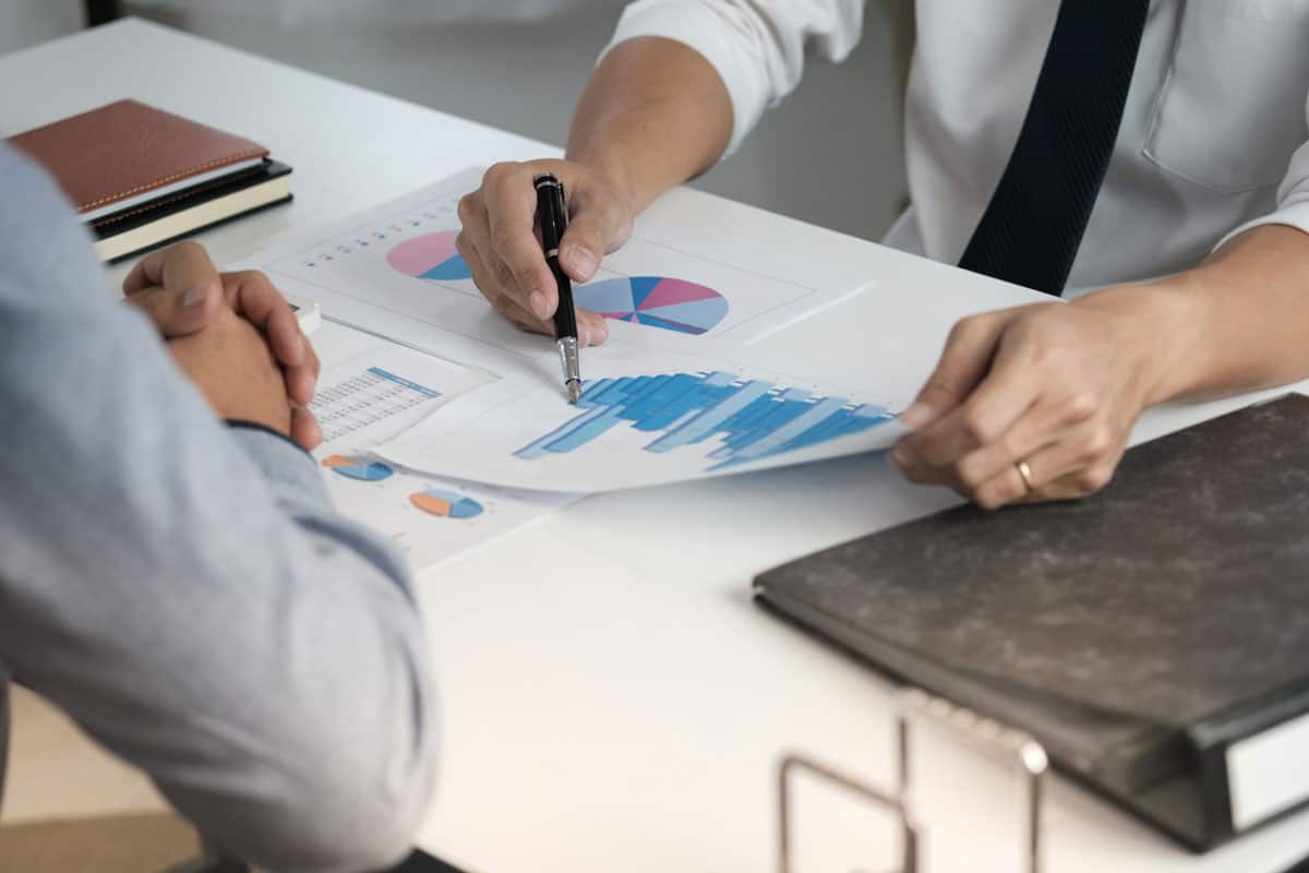 two office staff conducting an internal audit and checking financial documents of a company