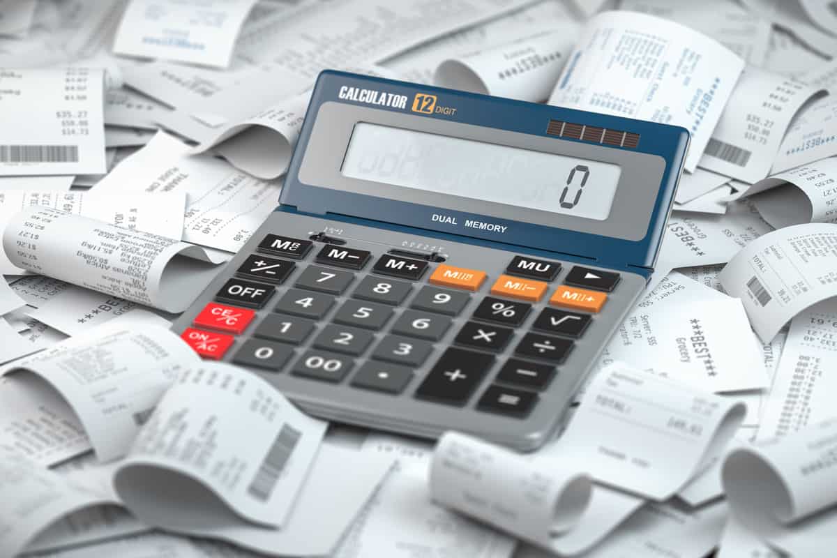 calculator on top of a pile of receipts showing vat taxes