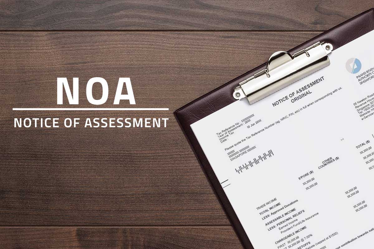 Large white text saying NOA Notice of Assessment against a background showing income tax bill attached on a clipboard resting atop a wooden table.