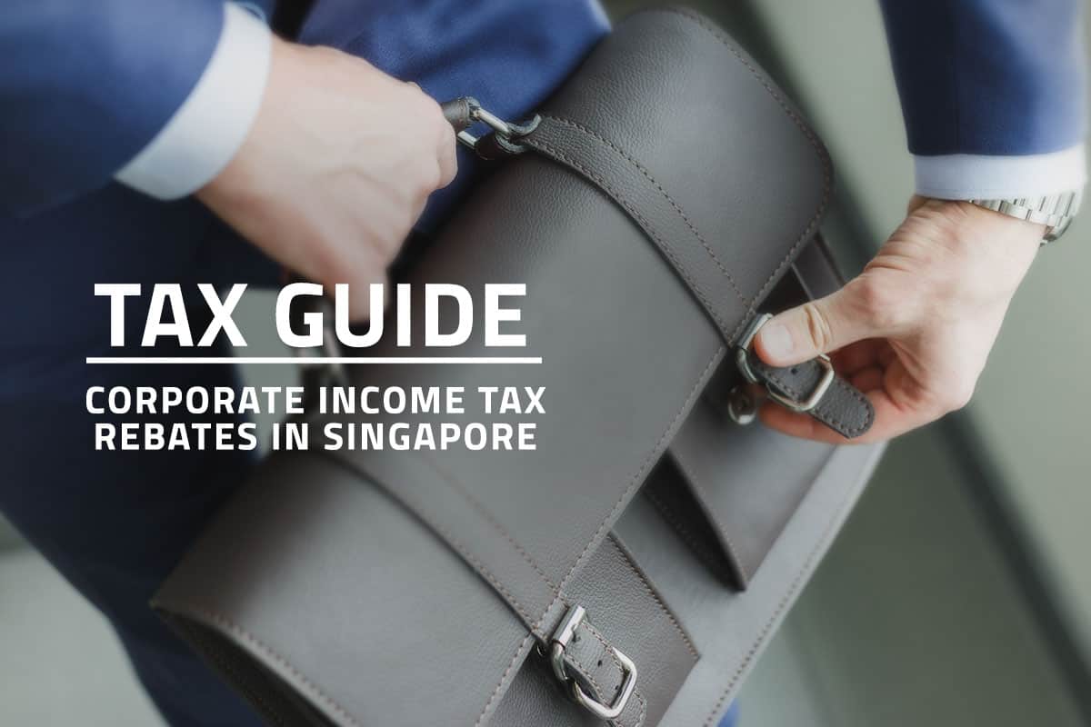 words tax guide corporate income tax rebates in singapore overlaying background closeup of a man in a suit carrying a company briefcase