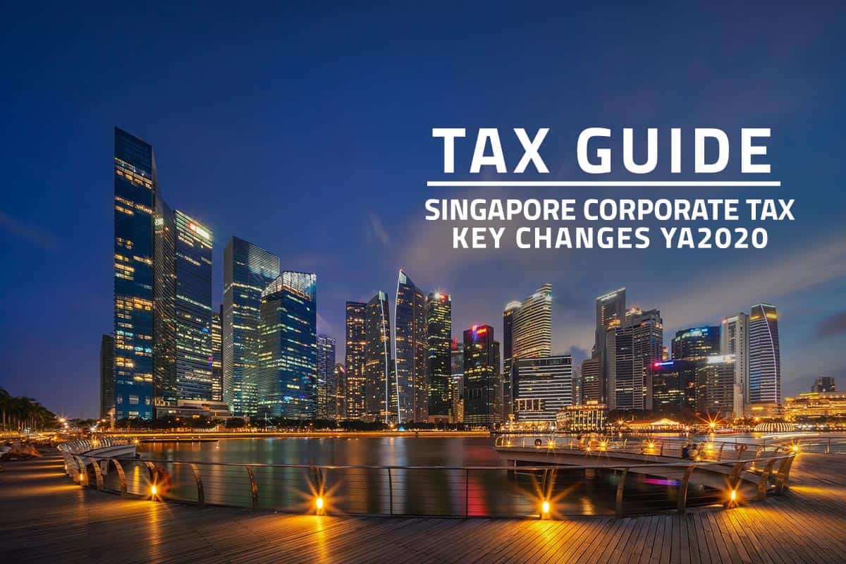 words tax guide Singapore corporate tax key changes ya2020 against background of Singapore financial district at night